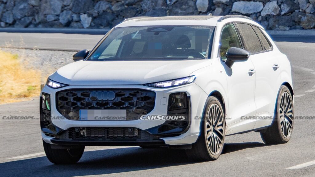 Spy shot of a camouflaged Audi SQ3 prototype with dual round exhaust tips (Photo credit: SH Proshots)